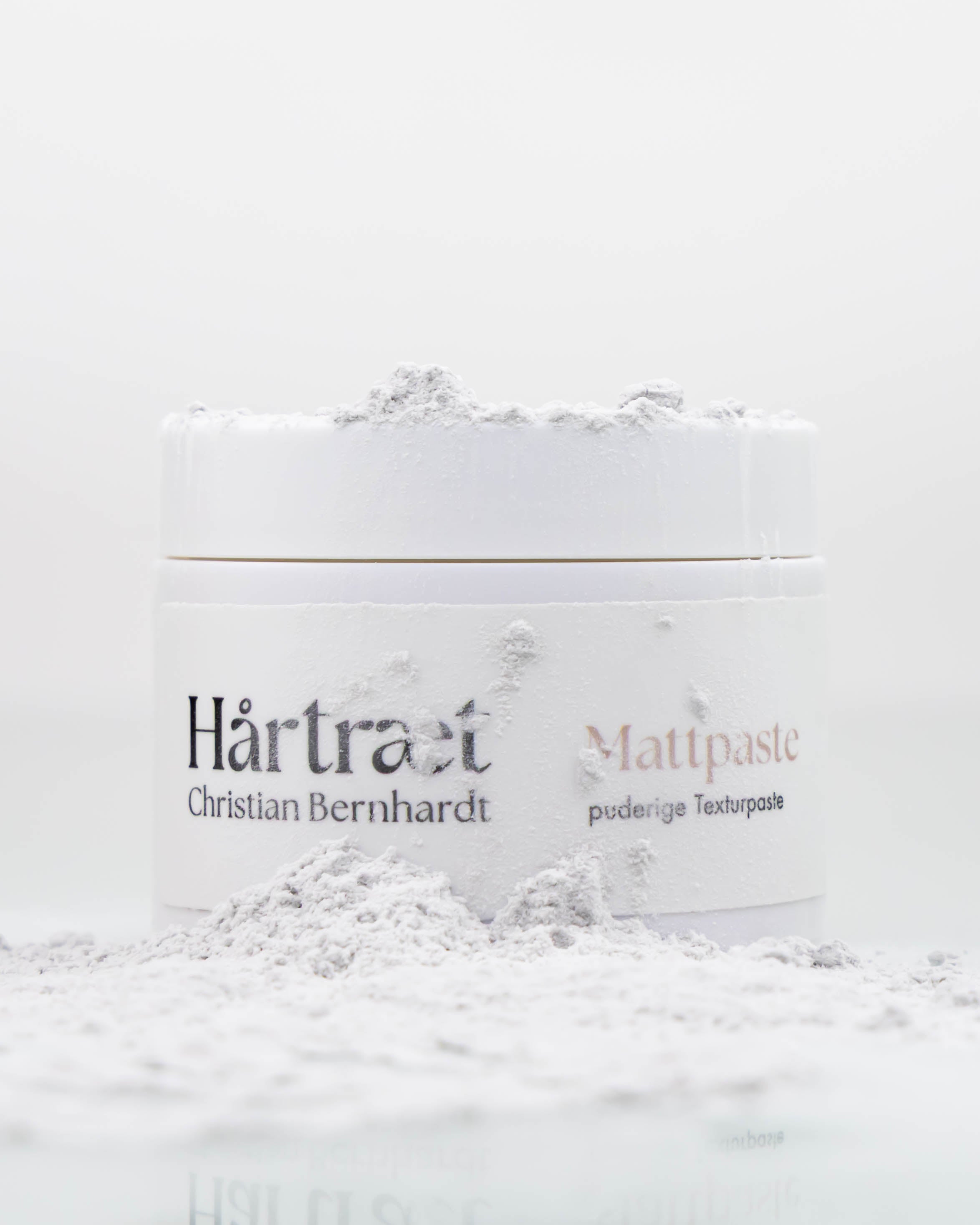 Eine Dose Mattpaste, auf der Puder ist
